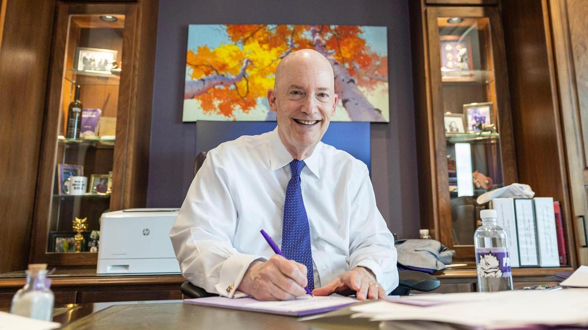 TCU Chancellor Victor J. Boschini Jr. is photographed signing notes in the his office on Friday, May 9, 2025. After 22 years at the helm, Boschini is stepping down from his role as chancellor.