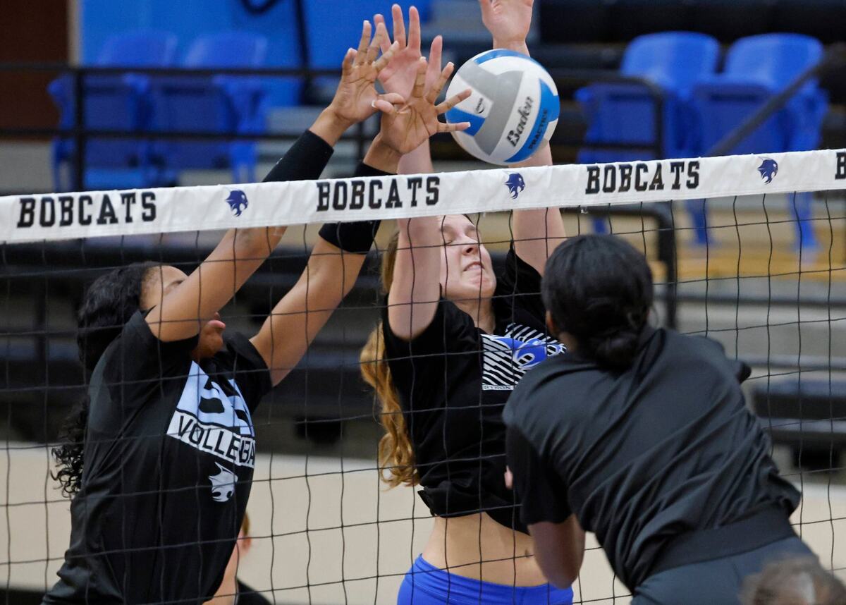Zion Coats and Kylie Kleckner attempt to block a shot during volleyball practice at Byron Nelson High School in Trophy Club Texas, Wednesday, Sept. 25, 2024.