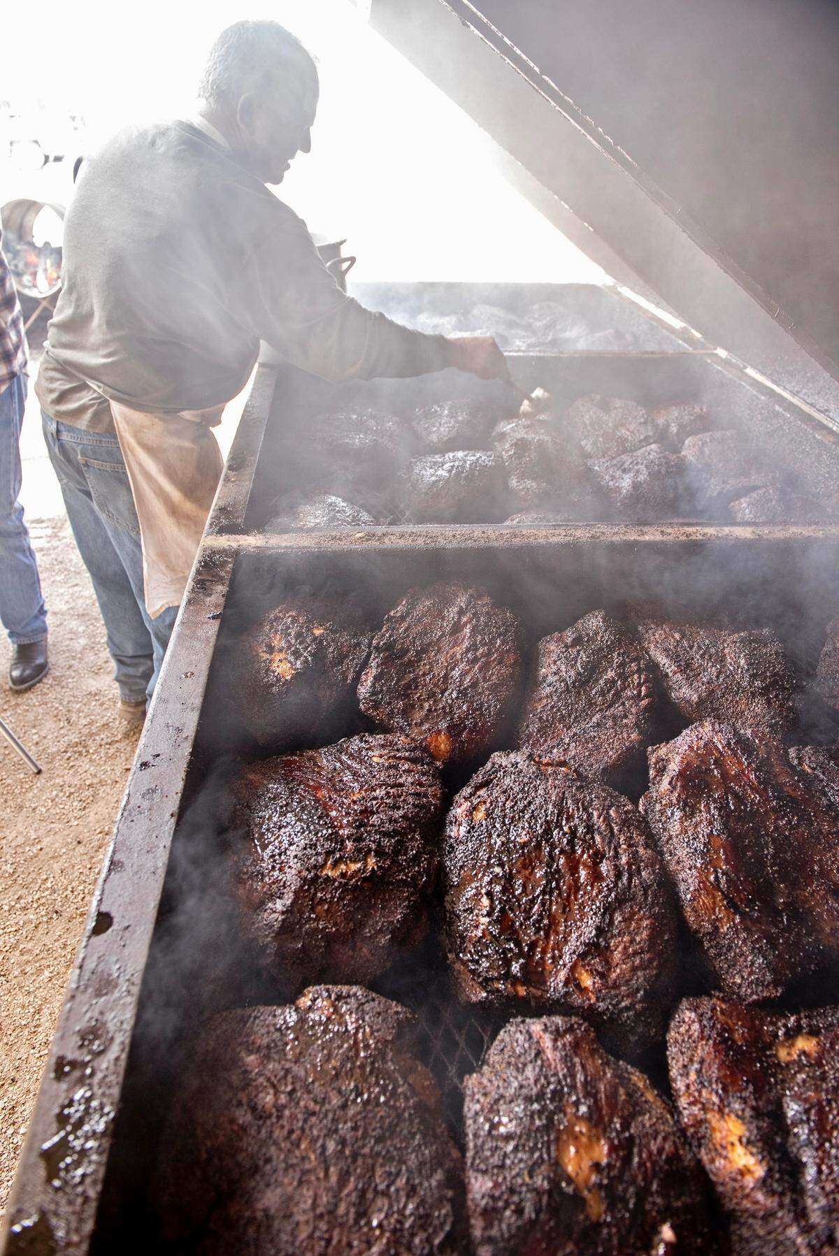 Briskets on the open mesquite pit at Perini Ranch Steakhouse.