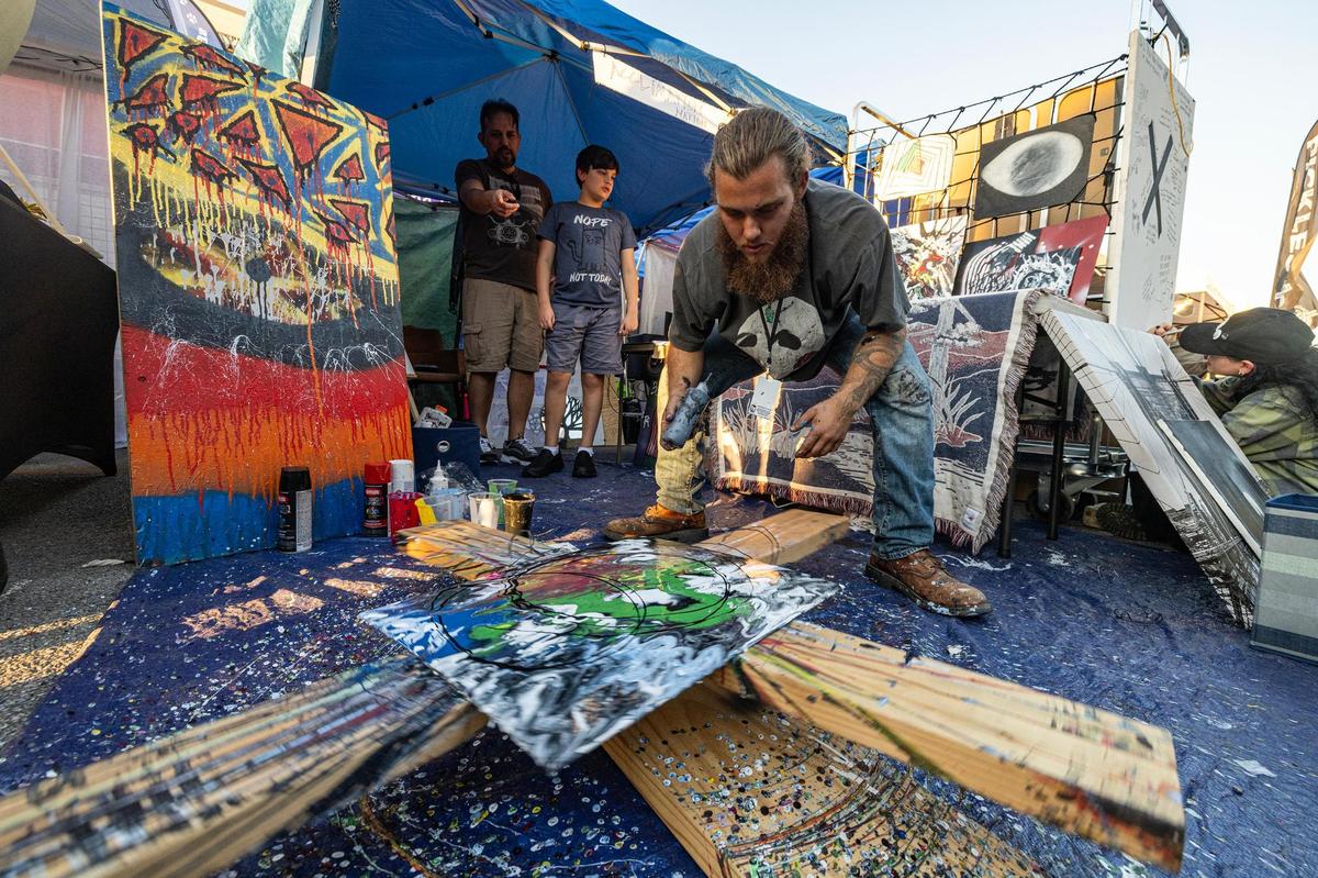 Spin artist Daniel Cannariato creates a painting using his man-made contraption in front of a crowd during the Arts Goggle event on Magnolia Avenue in Fort Worth on Saturday, Oct. 19, 2024.