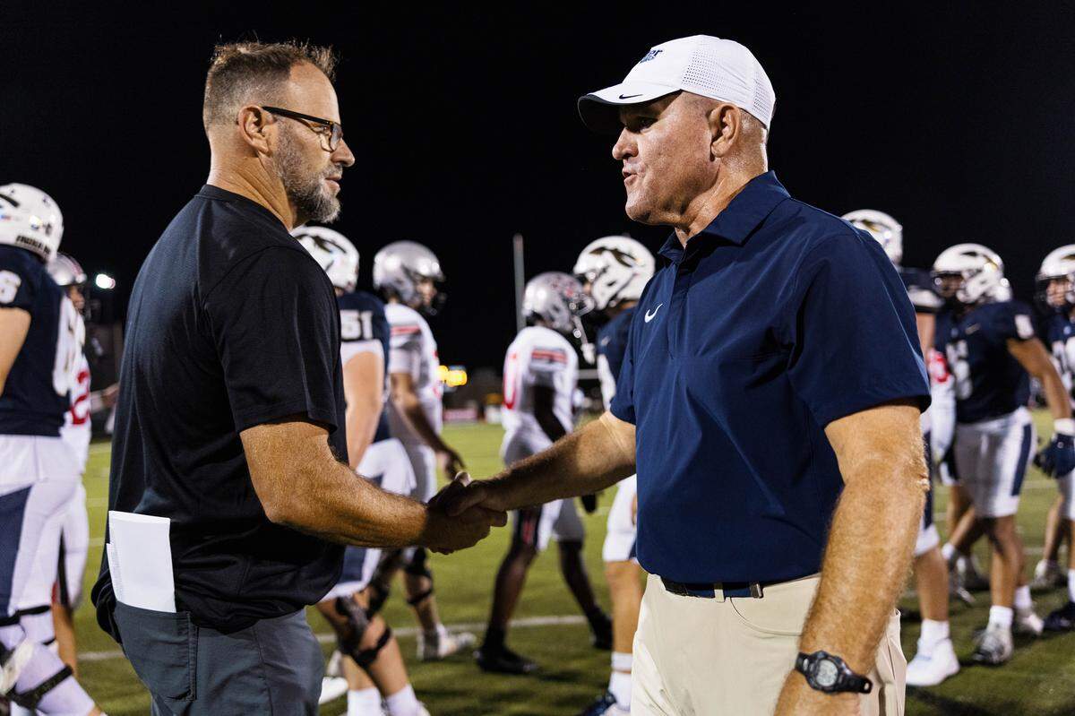 Keller Head Coach Carl Stralow shakes hands with Flower Mound Marcus Head Coach Mike Alexander following a 31-28 loss after a non-district game between Keller and Flower Mound Marcus at Keller ISD Stadium on August 28, 2025.
