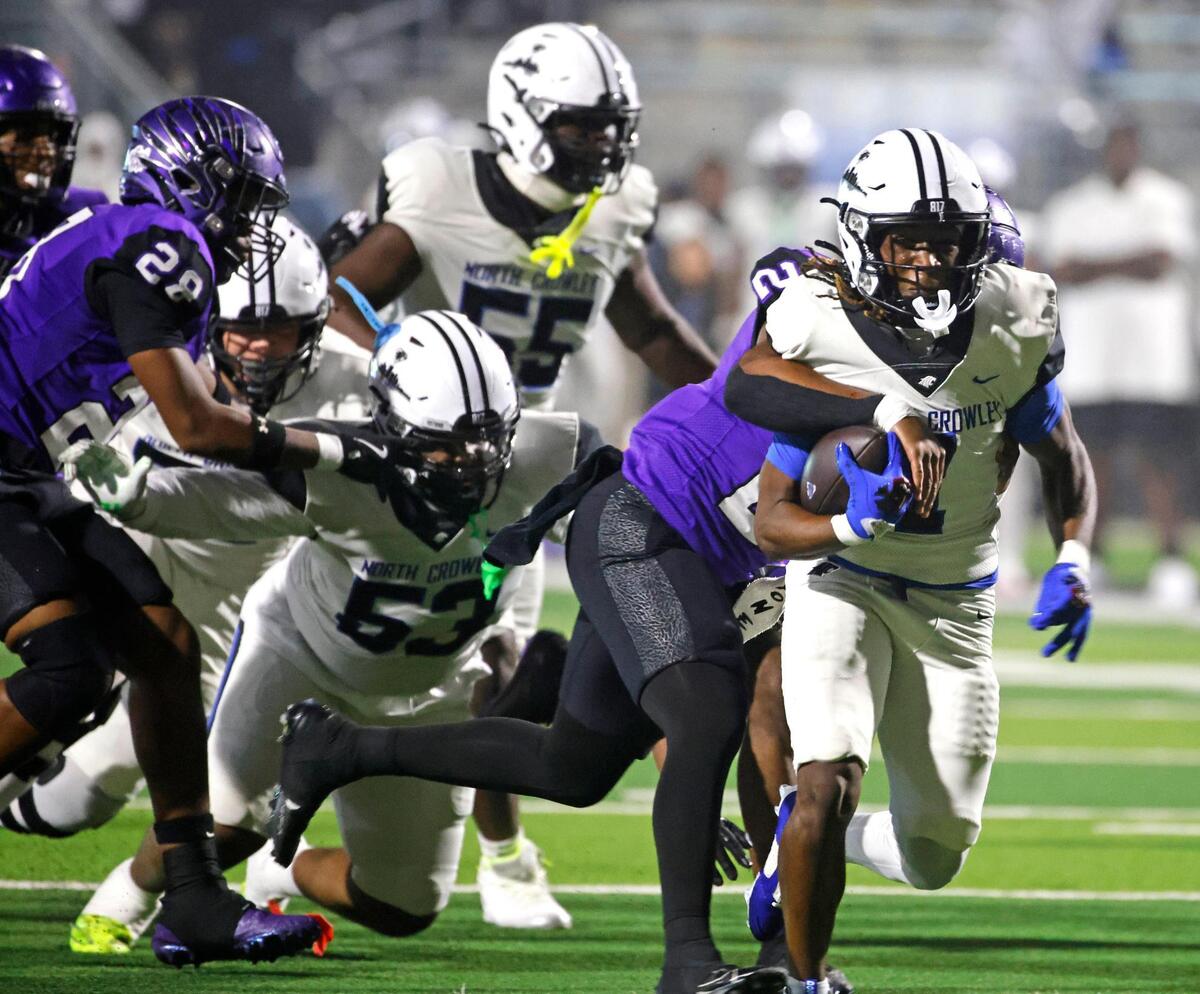 North Crowley running back Cornelius Warren (1) is brought down from behind by Crowley free safety Jonathan Blake (27) during a UIL District 3-6A football game at Crowley ISD Multi-Purpose Stadium in Fort Worth, Texas, Thursday, Nov. 07, 2024.