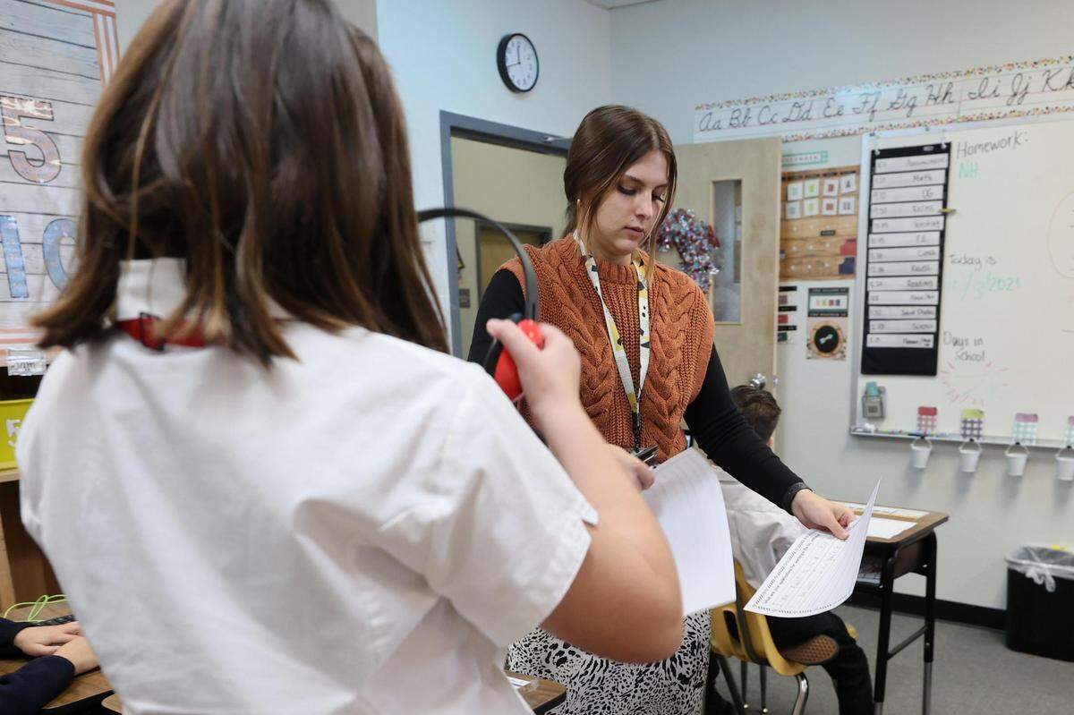 Teacher Melissa Richards looks over assignments from her students on Dec. 13, 2021, at Hill School of Fort Worth. The private school serves children with learning differences.