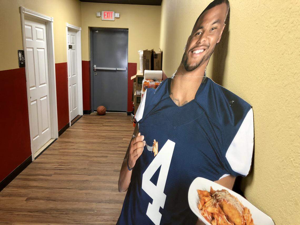The hallway at Smoke'N Ash BBQ included a Dak Prescott cut-out and a basketball.
