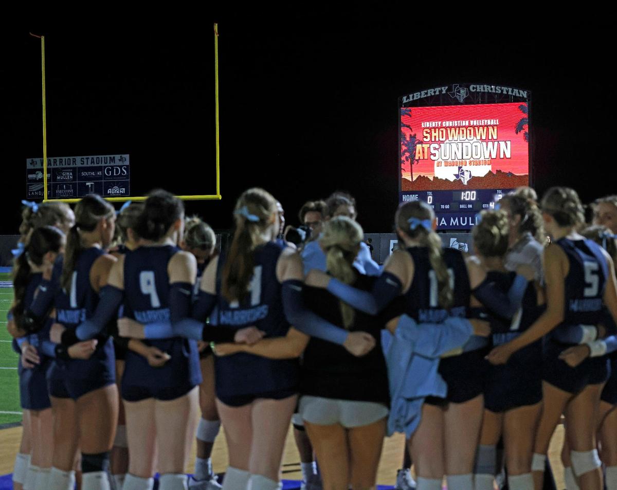 The Liberty Christian Warriors huddle after the Showdown at Sundown outdoor exhibition volleyball game at Liberty Christian High School in Argyle, Texas, Tuesday, Oct. 29, 2024.