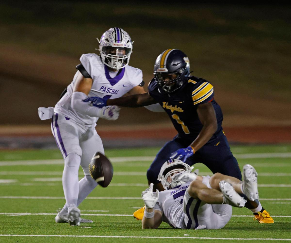 Arlington Heights running back Carson James (1) fumbles the ball during the Battle of the Bonfire UIL District 4-5A D1 football game at Farrington Field in Fort Worth, Texas, Friday, Nov. 08, 2024.