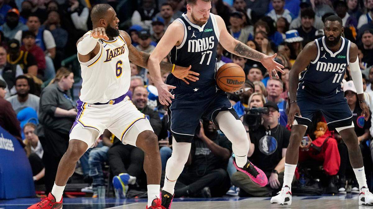 Los Angeles Lakers forward LeBron James (6) and Dallas Mavericks guard Luka Doncic (77) vie for control of the ball during their game on Sunday at American Airlines Center. 