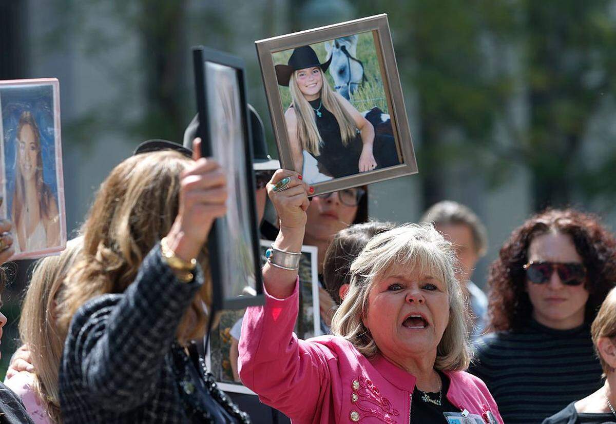 LOS ANGELES, CALIFORNIA - MARCH 25: Lori Schott, a plaintiff who has filed a lawsuit against social media companies for the death of her daughter, holds a photo as she speaks to reporters outside of the Los Angeles Superior Court on March 25, 2026 in Los Angeles, California. A Los Angeles jury found social media giants Meta and Google liable for designing addictive social media platforms that harmed a young woman's mental health. (Photo by Justin Sullivan/Getty Images)