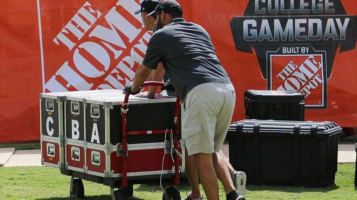 ESPN stage crew members set up the main stage for their braodcast before ESPN’s College GameDay broadcast in 2017 at TCU.