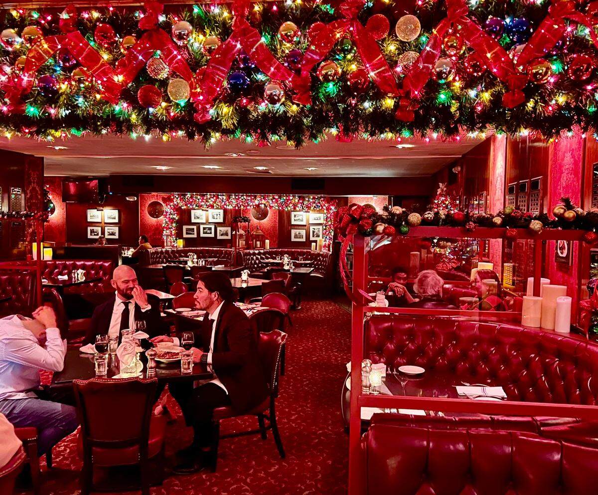 The classic decor (and, in this 2022 photo, Christmas decorations) at Durant’s steakhouse in Phoenix.