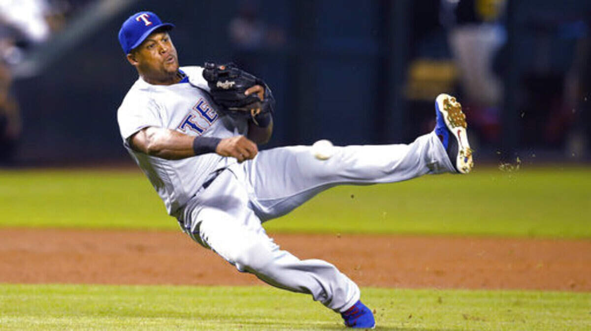 Texas Rangers third baseman Adrian Beltre makes the off balance throw for the out on a ball hit by Arizona Diamondbacks’ Paul Goldschmidt during the first inning during a baseball game Tuesday, July 31, 2018, in Phoenix. (AP Photo/Rick Scuteri)