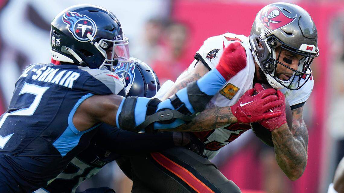 Tampa Bay Buccaneers wide receiver Mike Evans, right, runs past Tennessee Titans linebacker Azeez Al-Shaair (2) after a catch for a touchdown during the second half of an NFL football game Nov. 12. (AP Photo/Chris O’Meara)