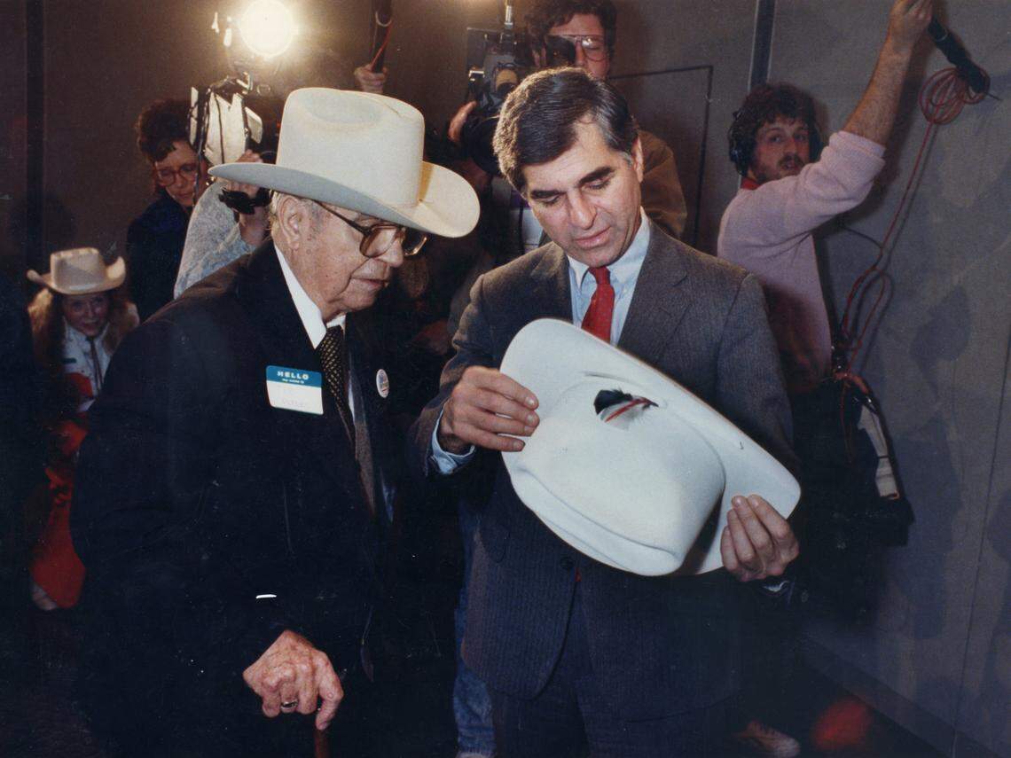 Feb. 19, 1988: Presidential hopeful Democrat Michael Dukakis, right, examines a cowboy hat presented to him by hatmaker Tom Peters at the Worthington Hotel in Fort Worth.
