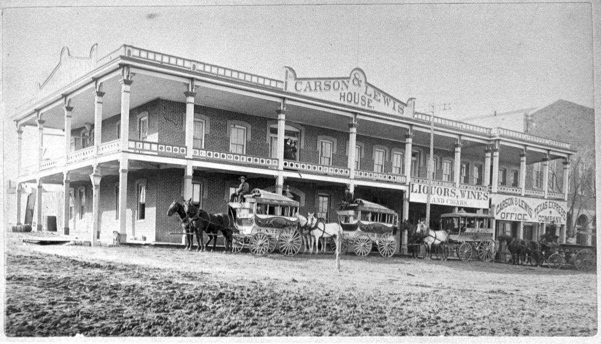 1884: Carson and Lewis House with horse and buggies in front owned by Baker Transfer Co., Weatherford Square.
