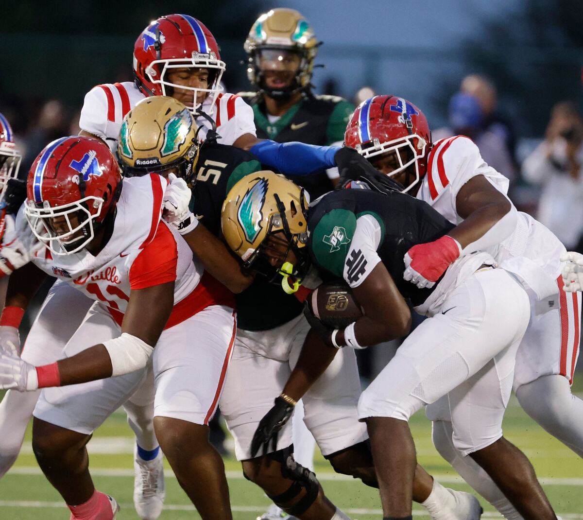 DeSoto running back Deondrae Riden (1) gets hard yards p the middle during a District 11-6A football game at Eagle Stadium in DeSoto, Texas, Friday, Oct. 11, 2024.