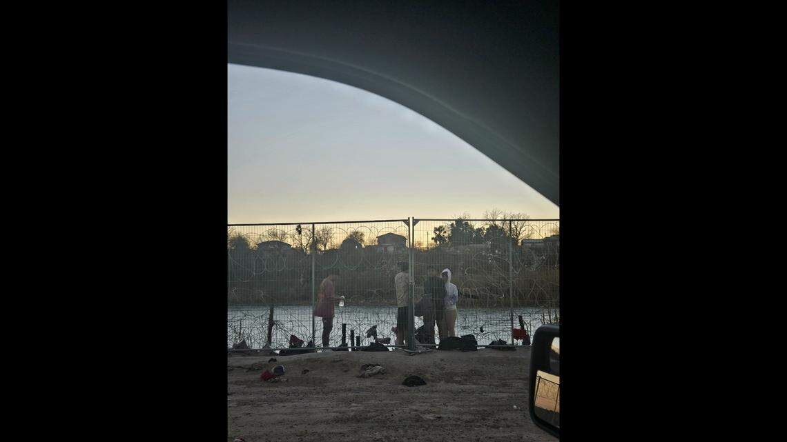 Young migrants attempt to break through the wire fencing at the border in Eagle Pass, Texas
