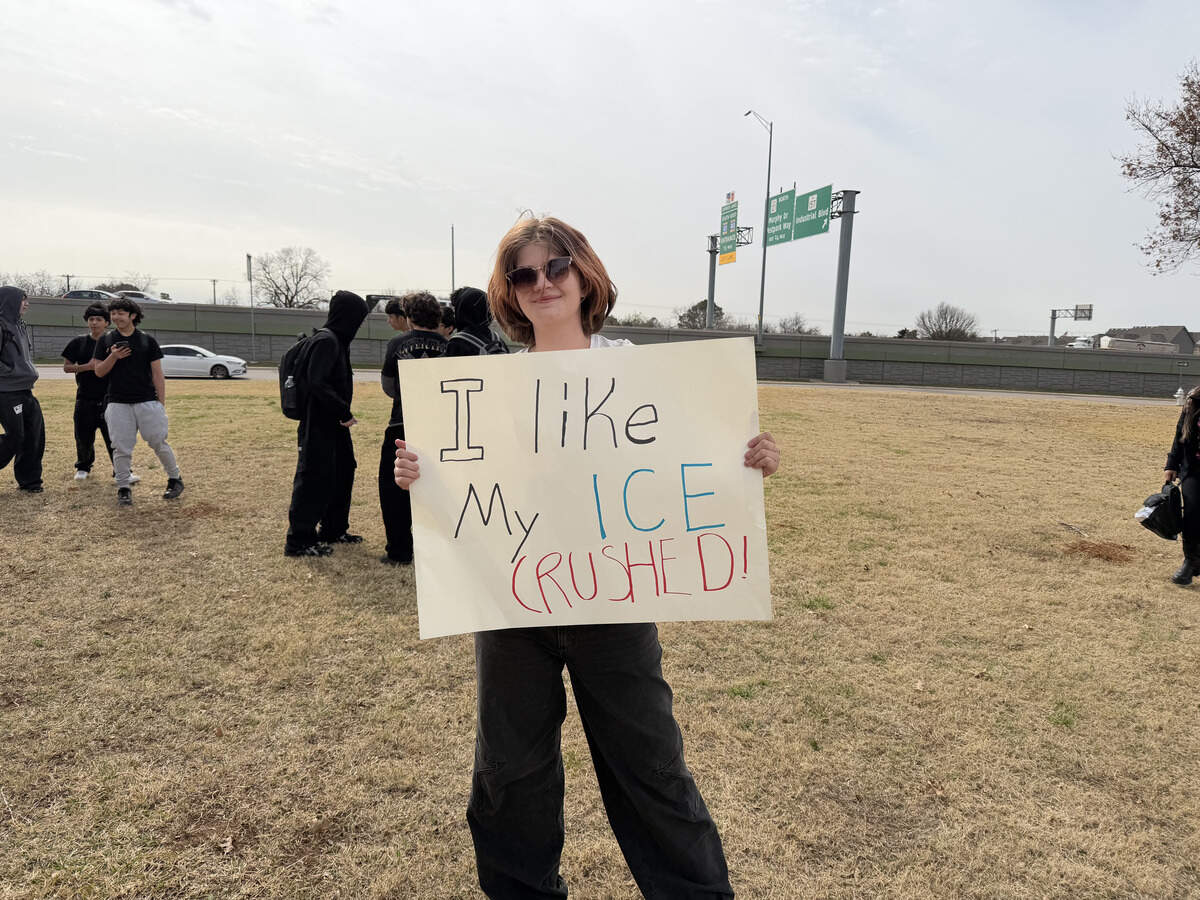 A student shows their anti-ICE sign during Friday’s walk out protest