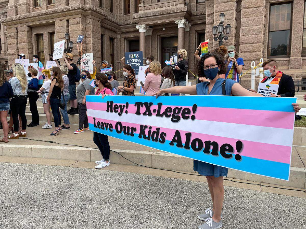 LGBTQ advocates protest legislation that affects transgender kids at the Texas Capitol on April 28, 2021.