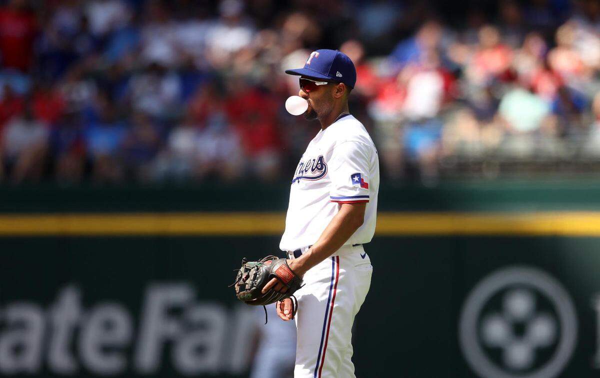 Texas Rangers second baseman Marcus Semien blows a bubble while waiting for the next Colorado Rockies batter on Monday, April 11, 2022, at Globe Life Field.