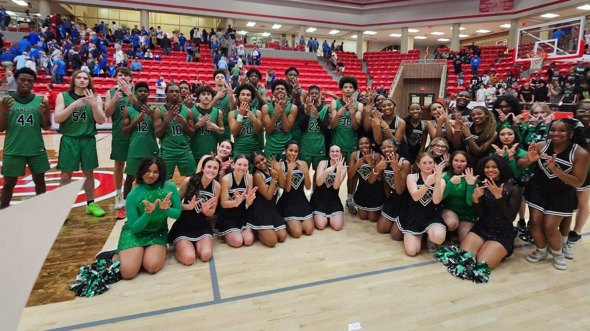 The Kennedale boys basketball team poses with the cheer squad after the Wildcats defeated Krum in a Class 4A Division 2 State Semifinal on Tuesday, March 4, 2025 at Glen Rose High School in Glen Rose, Texas.