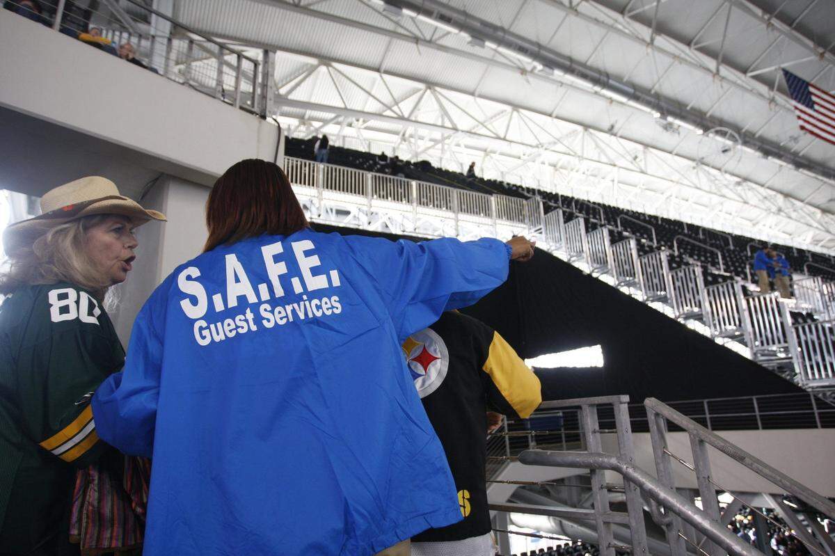 A ticket-holder (left) and guest services worker discuss the situation after some fans were denied access to the seats they bought for Super Bowl XLV at Cowboys Stadium Sunday, February 6, 2011,  in Arlington, TX. Star-Telegram/Richard W. Rodriguez
