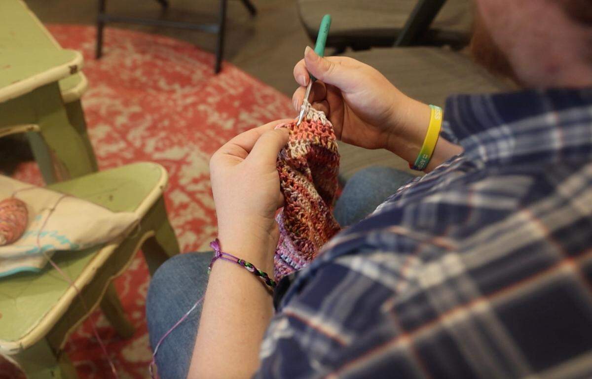 Bertie Gardner, the program director for LGBTQ Saves, crochets a peplum top for his mother at JuJu Knits in Fort Worth. The yarn store is hosting a fundraiser for LGBTQ Saves during the month of June.