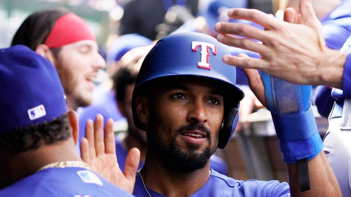 Second baseman Marcus Semien (2) is greeted in the dugout after scoring against the Chicago Cubs during the Texas Rangers’ 8-2 win at Wrigley Field on Sunday.