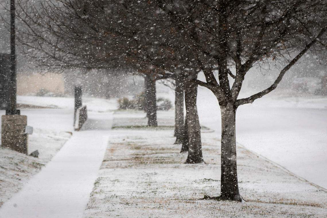 Snow sticks to the roads along Camp Bowie Blvd. on Feb. 14, 2021, in Fort Worth.
