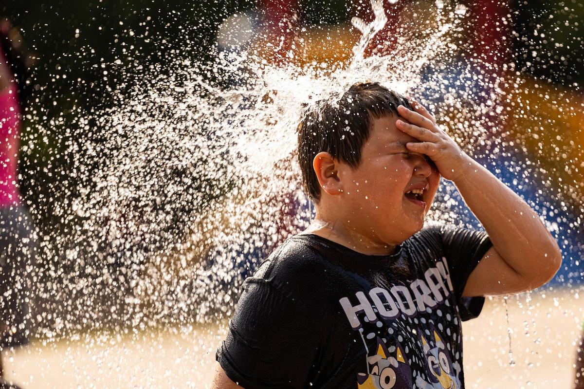 Adrian Olmos, 10, cools down on the splash pad at Sycamore Water Park in Fort Worth on Thursday, June 27, 2024. Temperatures rose to over 100 degrees as the summer heatwave begins to heat up.