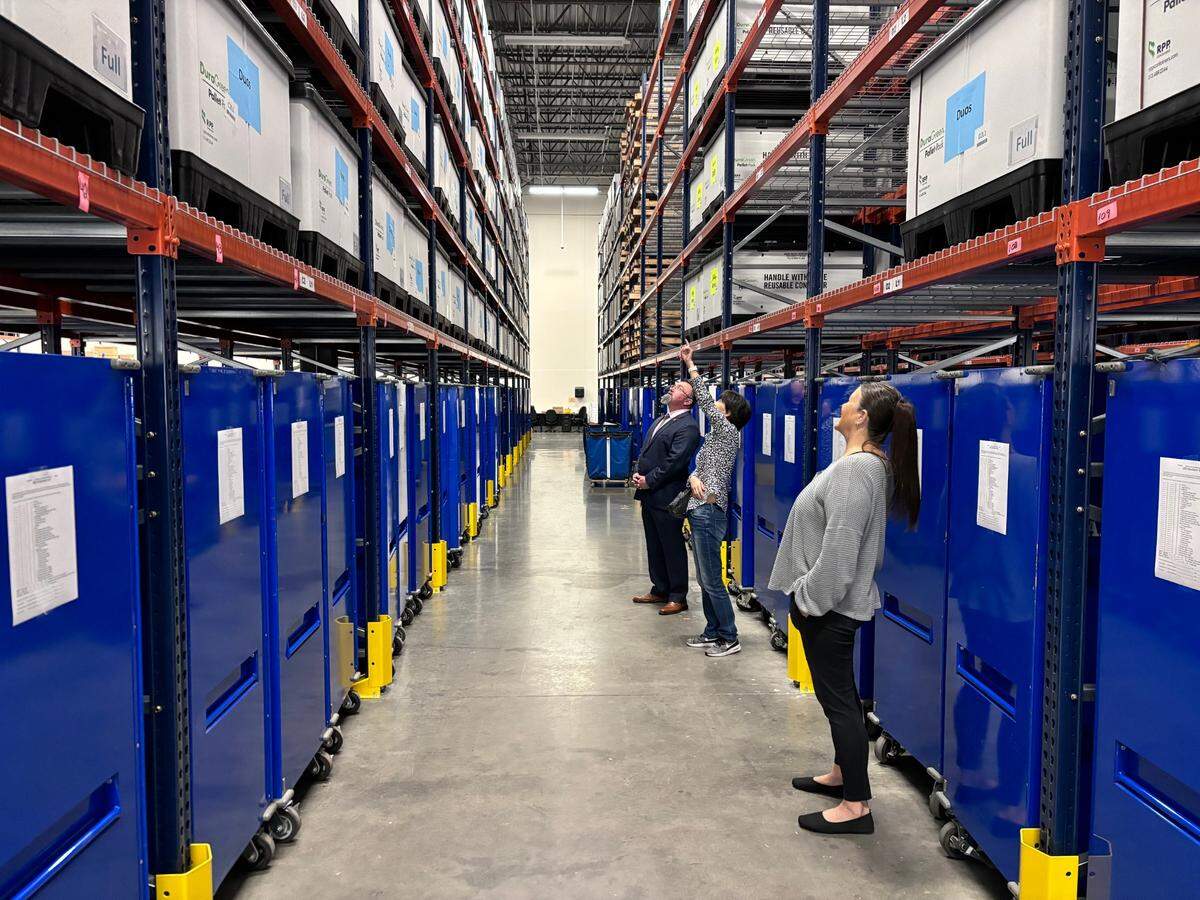 Poll watcher Mei Wang points to a box from which she plans to pick a voting machine at a public test of Tarrant County’s election equipment and processes in Fort Worth on Sept. 16, 2024.