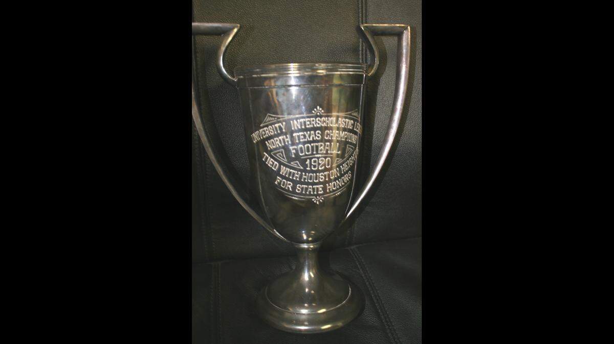 The 1920 Texas high school football state championship trophy displayed in the Cleburne gym. Cleburne and Houston Heights were co-champs after a scoreless tie.