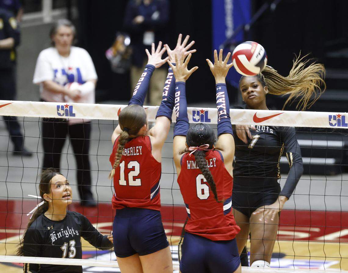 Fort Worth Eagle Mountain setter Molly Aubert (13) watches as middle blocker Keoni Williams (1) lifts a shot over the defense of Wimberley outside hitter Trinity Laney (12) and middle hitter Mariah McCoy (6) during the first set of the UIL Class 4A Division II state volleyball championship game Friday Nov. 21, 2025 at Curtis Culwell Center in Garland, Texas.