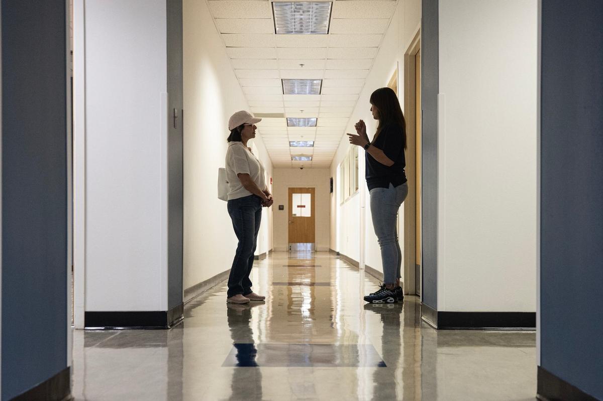 Prospective student Dina Moore, left, takes a tour around the campus with Chief Operating Officer Leticia Serna during an open house event for the New Heights Adult High School in Fort Worth on Aug. 9. New Heights is operated by Tarrant County College and will enable adults 18-50 to simultaneously earn a full high school diploma and job certification in one of at least 10 career and technical programs.