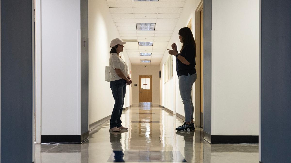 Prospective student Dina Moore, left, takes a tour around the campus with Chief Operating Officer Leticia Serna during an open house event for the New Heights Adult High School in Fort Worth on Aug. 9. New Heights is operated by Tarrant County College and will enable adults 18-50 to simultaneously earn a full high school diploma and job certification in one of at least 10 career and technical programs.
