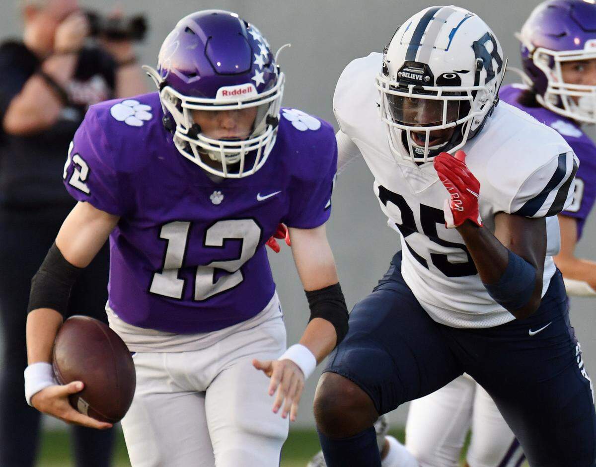 Paschal quarterback Will Henry, left is chased out of the backfield by Richland’s Kendle Arnold in the first quarter of their non-district football game Thursday, September 2, 2021 at the Birdville Fine Arts Athletic Complex in North Richland Hills, Texas. Special/Bob Haynes