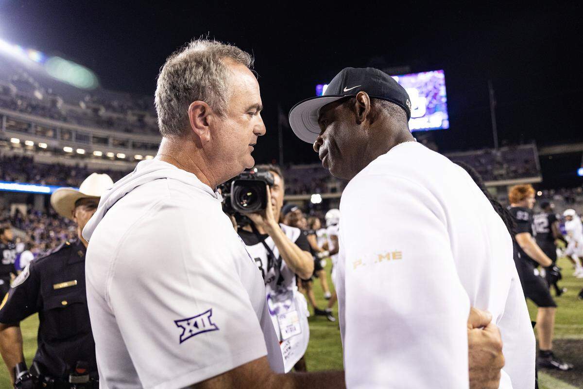 TCU head coach Sonny Dykes, left, and Colorado head coach Deion Sanders, right, embrace following an NCAA football game between TCU and Colorado at Amon G. Carter Stadium in Fort Worth on Saturday, Oct. 4, 2025. TCU defeated Colorado 35-21.