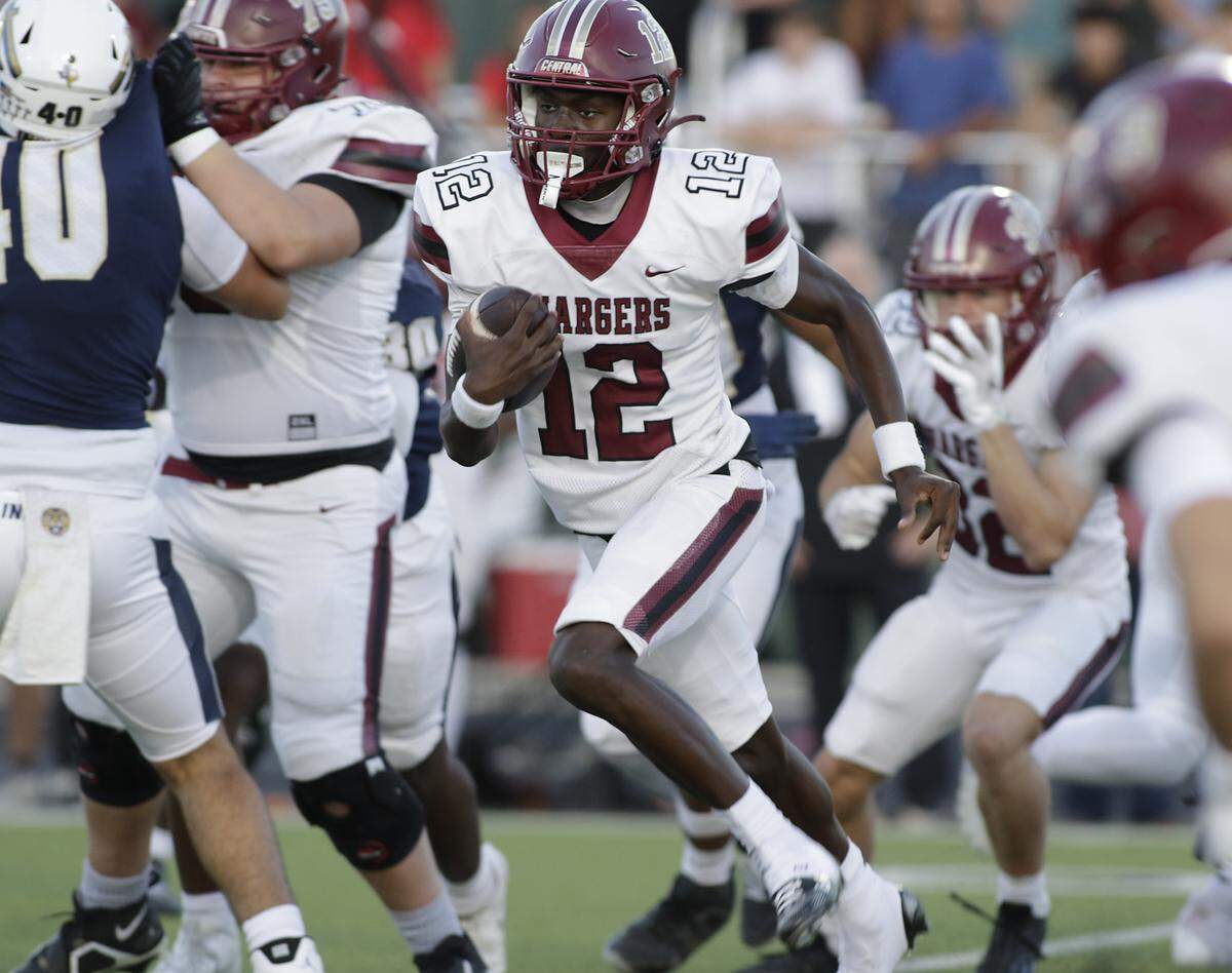 Keller Central’s Isaiah Taylor (12) picks up yardage against Keller during their game at Keller ISD Athletic Complex on Friday, Sep. 26, 2025.