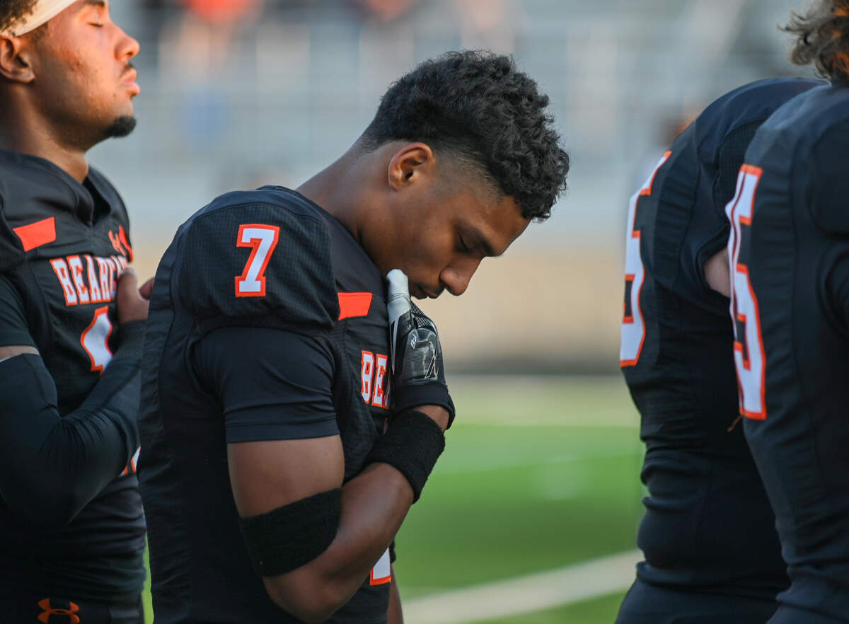 Aledo cornerback Adrian Fuller closes his eyes during the national anthem prior to a game against Lancaster high School on Sept. 6 at Tim Buchanan Stadium. Fuller had one interception in the game.