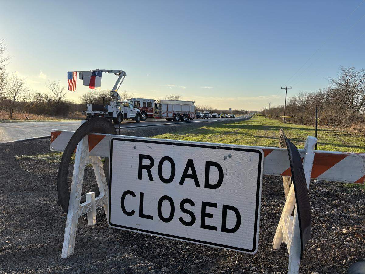 Commissioner Manny Ramirez cut the ribbon on Shelton Ranch Road as the sun came up Dec. 18, 2025. Residents of the Vista Ridge neighborhood on Tinsley Lane have been halted for hours at a time because of the trains blocking the one entrance to their community.