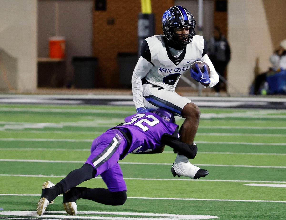 North Crowley running back Ashton Searl (8) attempts to get away from Crowley wide receiver Julius Washington (32) in the first half of a UIL high school football game at Crowley ISD Multi-Purpose Stadium in Fort Worth, Texas, Thursday, Nov. 02, 2023.