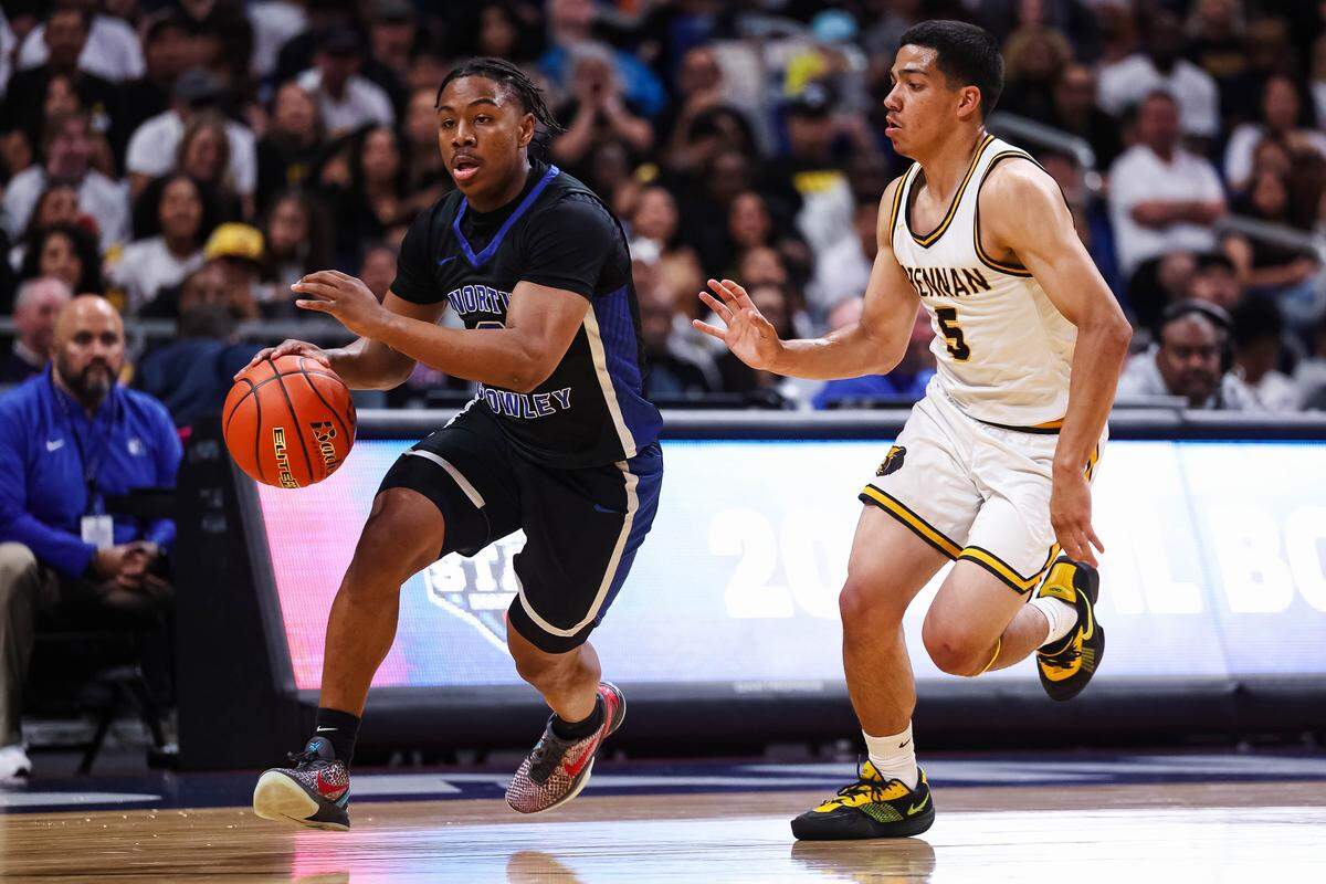 North Crowley guard Kameron Price (2) drives with the ball as a San Antonio Brennan defender trails in the Class 6A Division I state championship at The Alamodome in San Antonio, Texas, March 14, 2026.