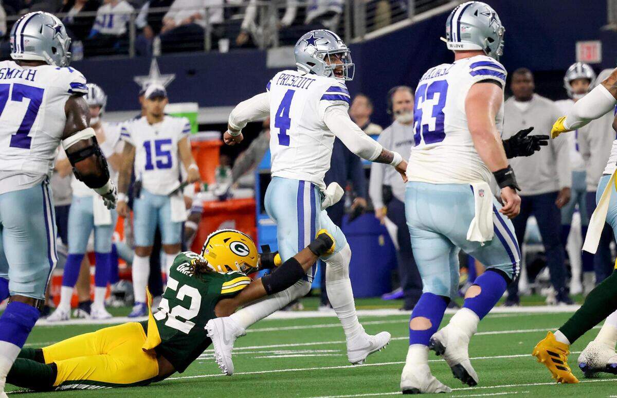 Dallas Cowboys quarterback Dak Prescott tosses the ball away before Green Bay Packers lineman Rashan Gary can take him down during the third quarter of the NFC wild-card playoff game against the Green Bay Packers on Sunday, January 14, 2024, at AT&T Stadium in Arlington.