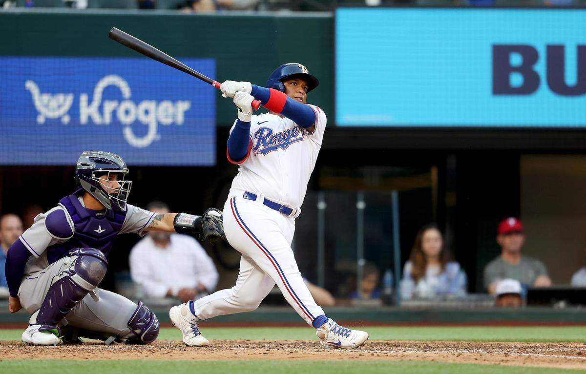Texas Rangers pinch hitter Willie Calhoun hits g a home run to tie the game in the bottom of the 9th inning against the Colorado Rockies on Monday, April 11, 2022, at Globe Life Field.