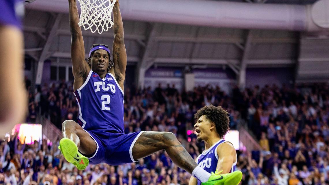 TCU forward Emanuel Miller hangs off the rim after dunking during their game against Texas at Schollmaier Arena in Fort Worth on Wednesday, March 1, 2023. TCU beat Texas 75-73.