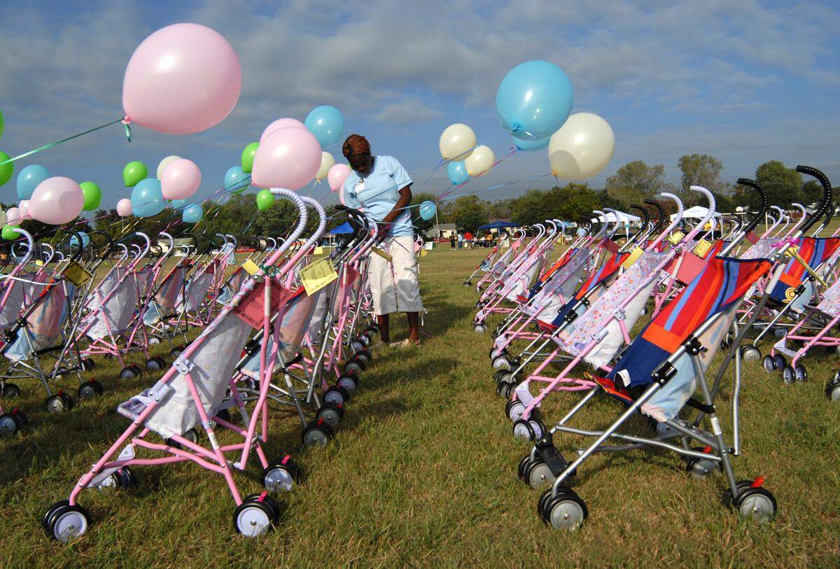 2007: Kaemah Cooper ties balloons to baby strollers during the 2nd Annual Stroller-Thon at Eastover Park in east Fort Worth. The 177 strollers represented the number of infant deaths in Tarrant County in 2004