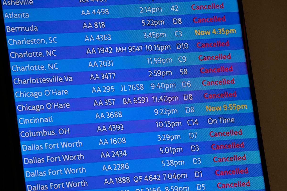 FILE - The arrivals board at the American Airlines terminal at LaGuardia Airport displays the flights that have been canceled or delayed and one that is on time, March 21, 2020, in New York. (AP Photo/Mary Altaffer, File)