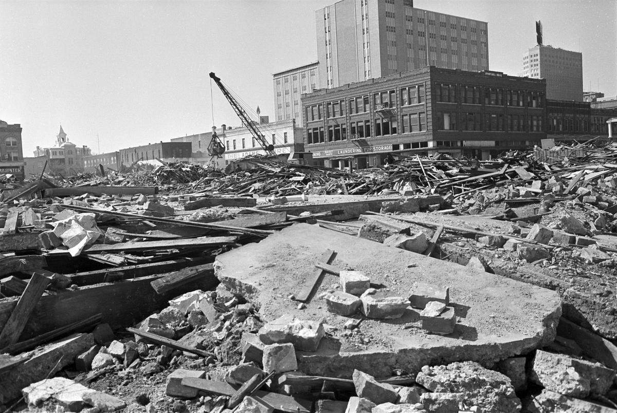 Demolition work was still ongoing eight months after the initial block was torn down. Building debris covers the ground with St. Ignatius Academy, back left, and the Southwestern Bell mid-rise tower and Fair Building (Service Life Insurance) to the right.