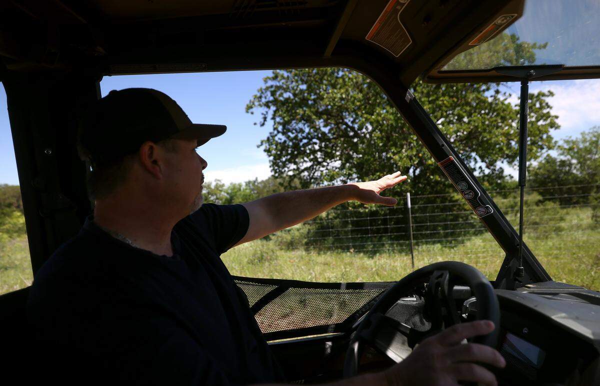 Graham land owner Ryan Mote points to a fence that separates his land from a proposed datacenter development on Friday, April 24, 2026. Mote and other residents are fighting to keep the date center from being their next door neighbor. 