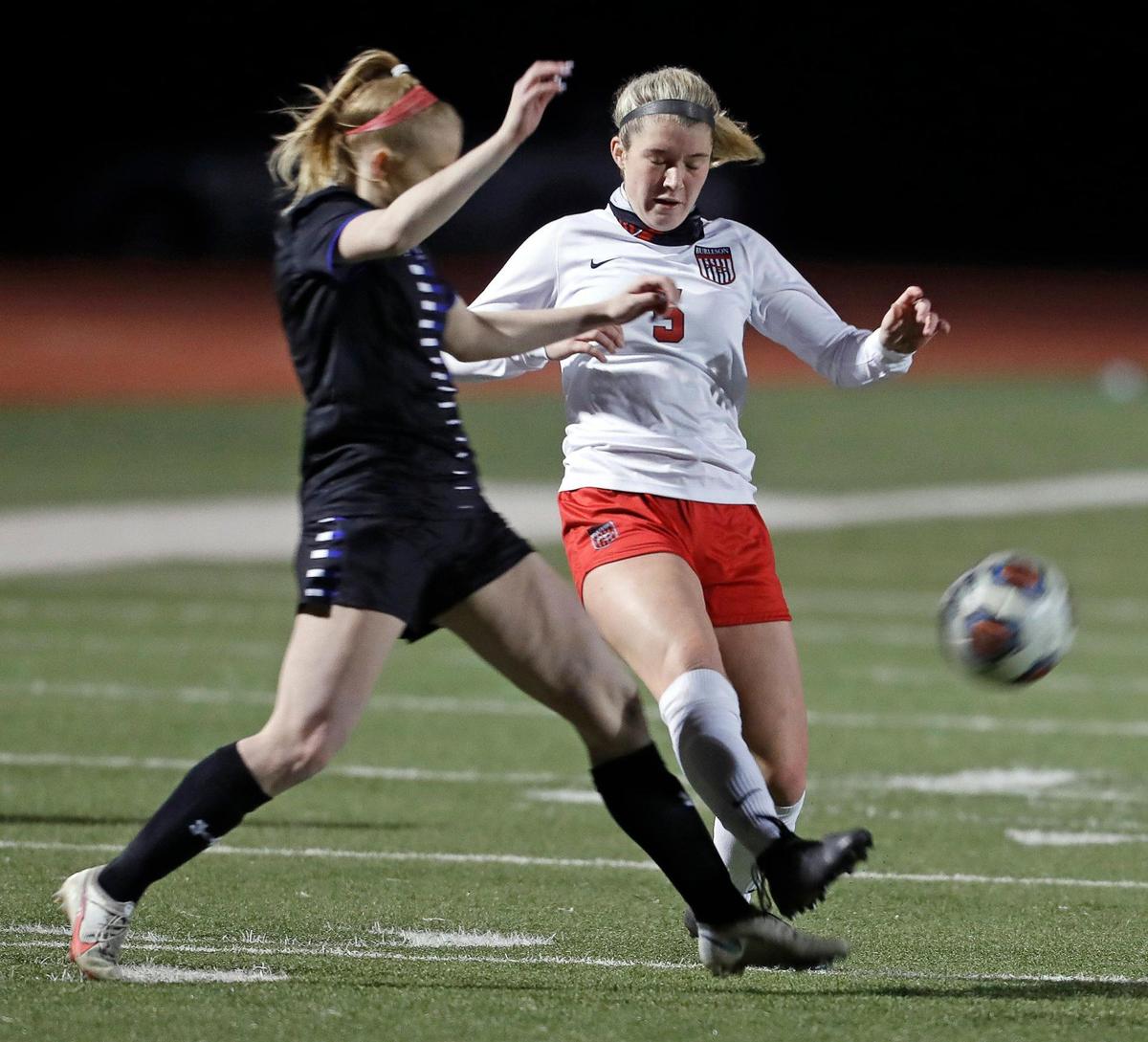Centennial defender Kayla Smith (4) reaches in for the kick by Burleson midfielder Jordan Walker (5) during a 8-5A girls soccer game at Burleson Centennial in Burleson, Texas, Friday, Feb. 05, 2021. Centennial defeated Burleson 6-0. (Special to the Star-Telegram Bob Booth)