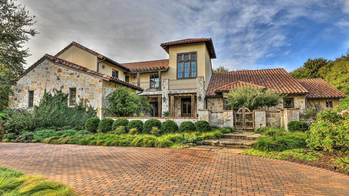 The home at 7001 Sanctuary Heights Road features a graceful flagstone courtyard with water feature.